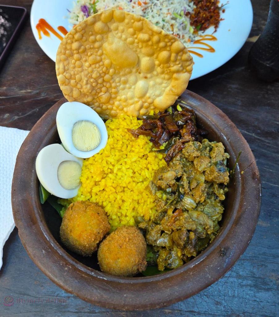 Traditional Claypot Meal - Garlic rice with lamb curry, brinjal moju, spiced cutlets, egg and papadam